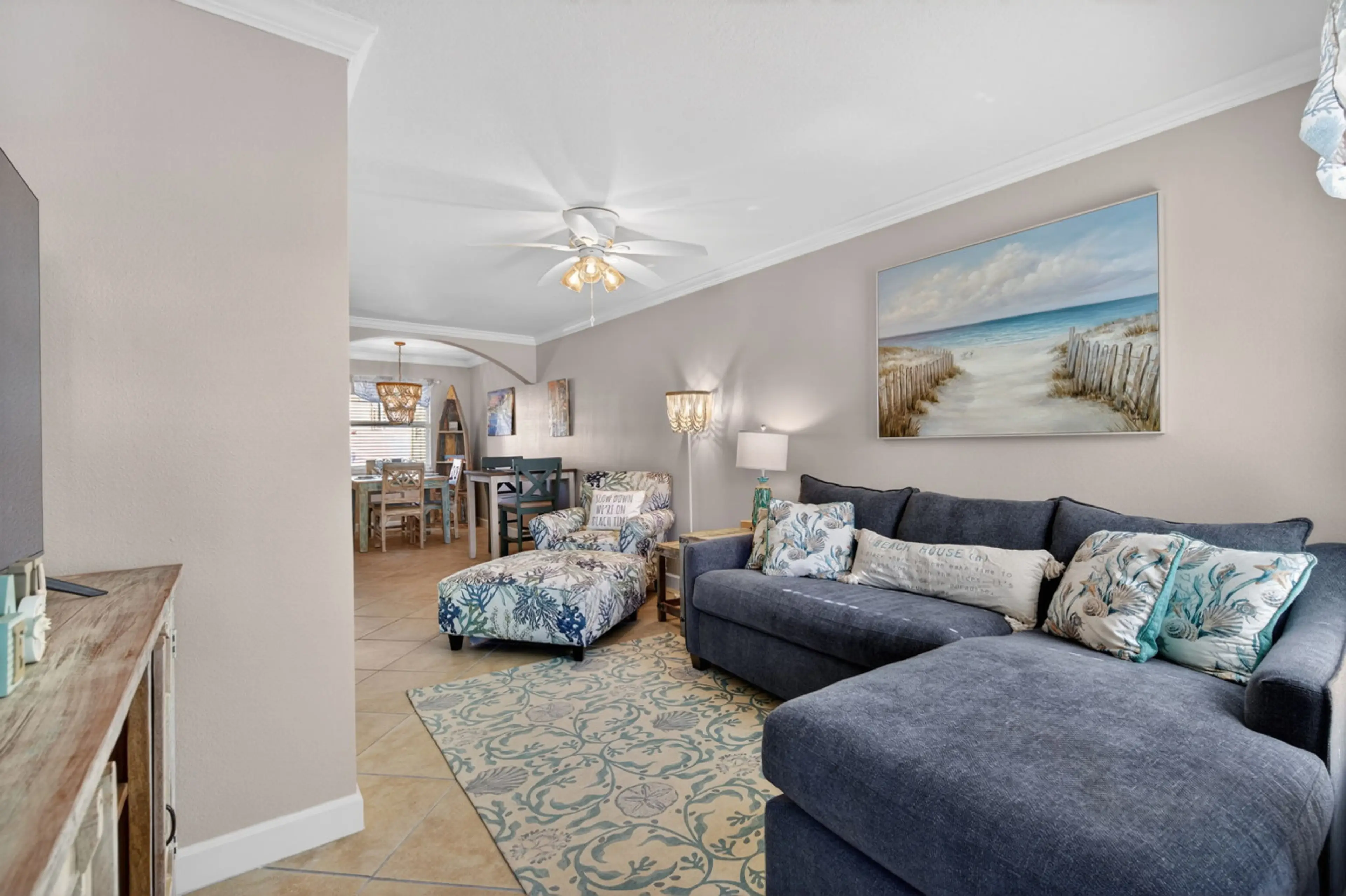 Cozy living room w/ plush sofa, coastal art & an open layout for easy lounging.