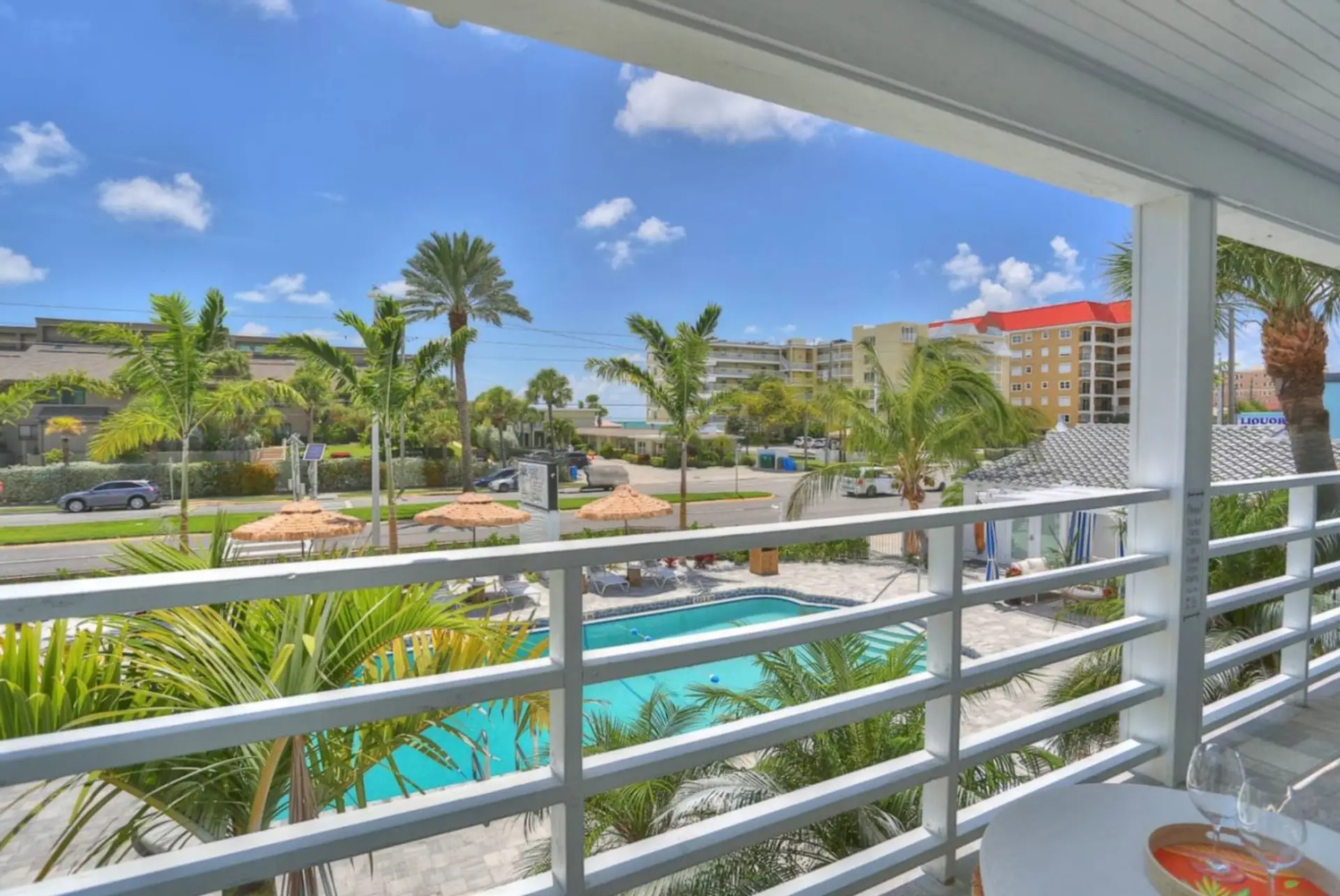 Balcony view overlooking the pool & palms, bringing tropical vibes right to you.
