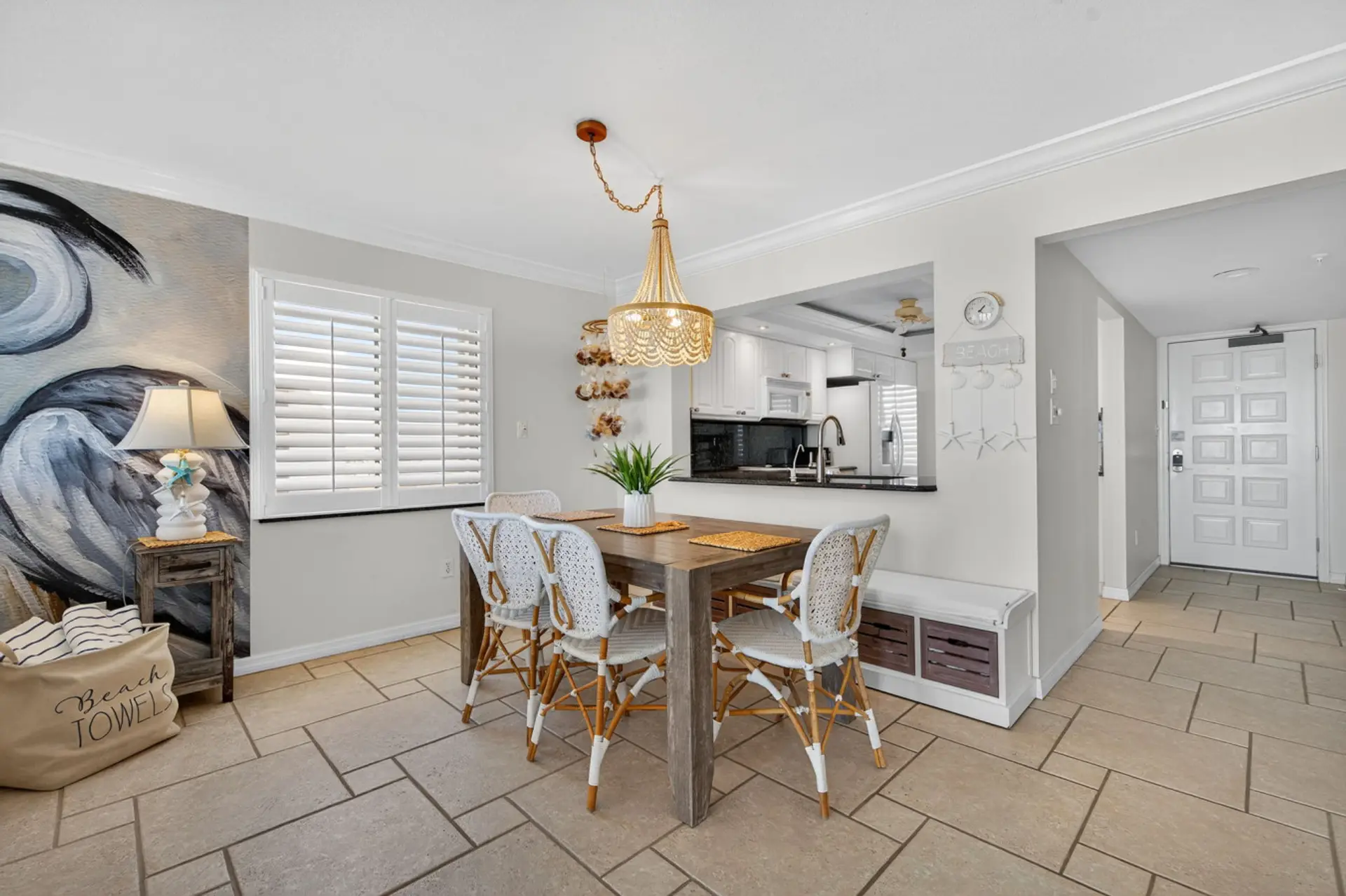 Open dining area w/ stylish lighting, flowing easily into the kitchen space.