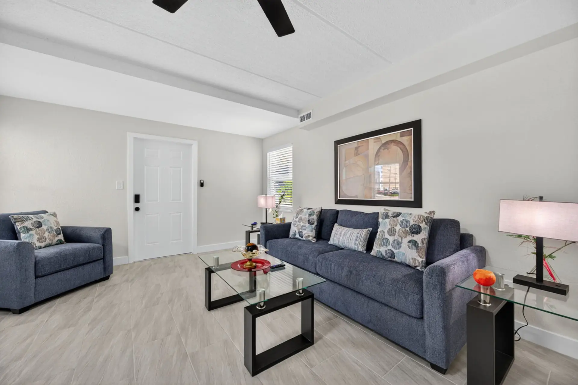 Bright living room w/ comfy seating, clean lines, and a relaxed setup for unwinding after a full day.