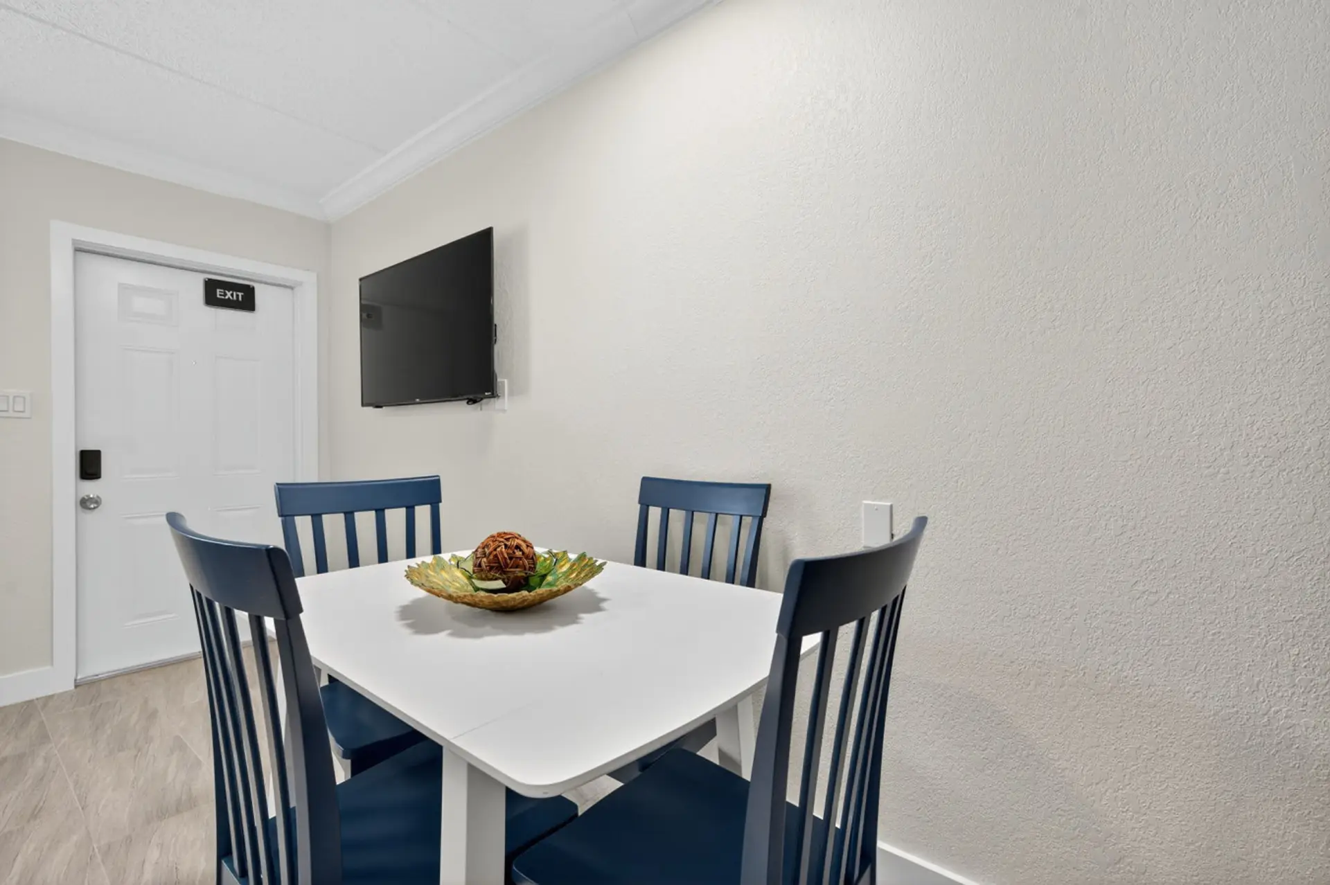 Bright dining nook w/ a simple table, perfect for casual meals and morning coffee.