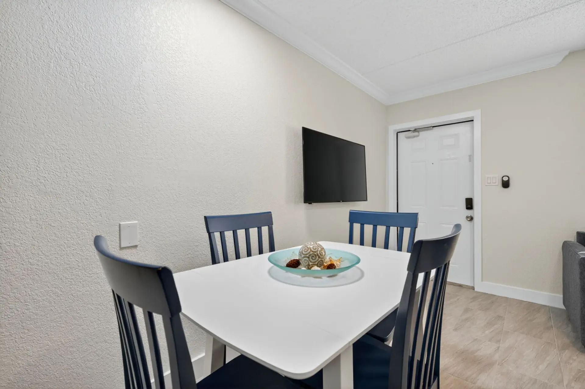Cozy dining area w/ modern table & chairs, ideal for shared meals or planning the day ahead.