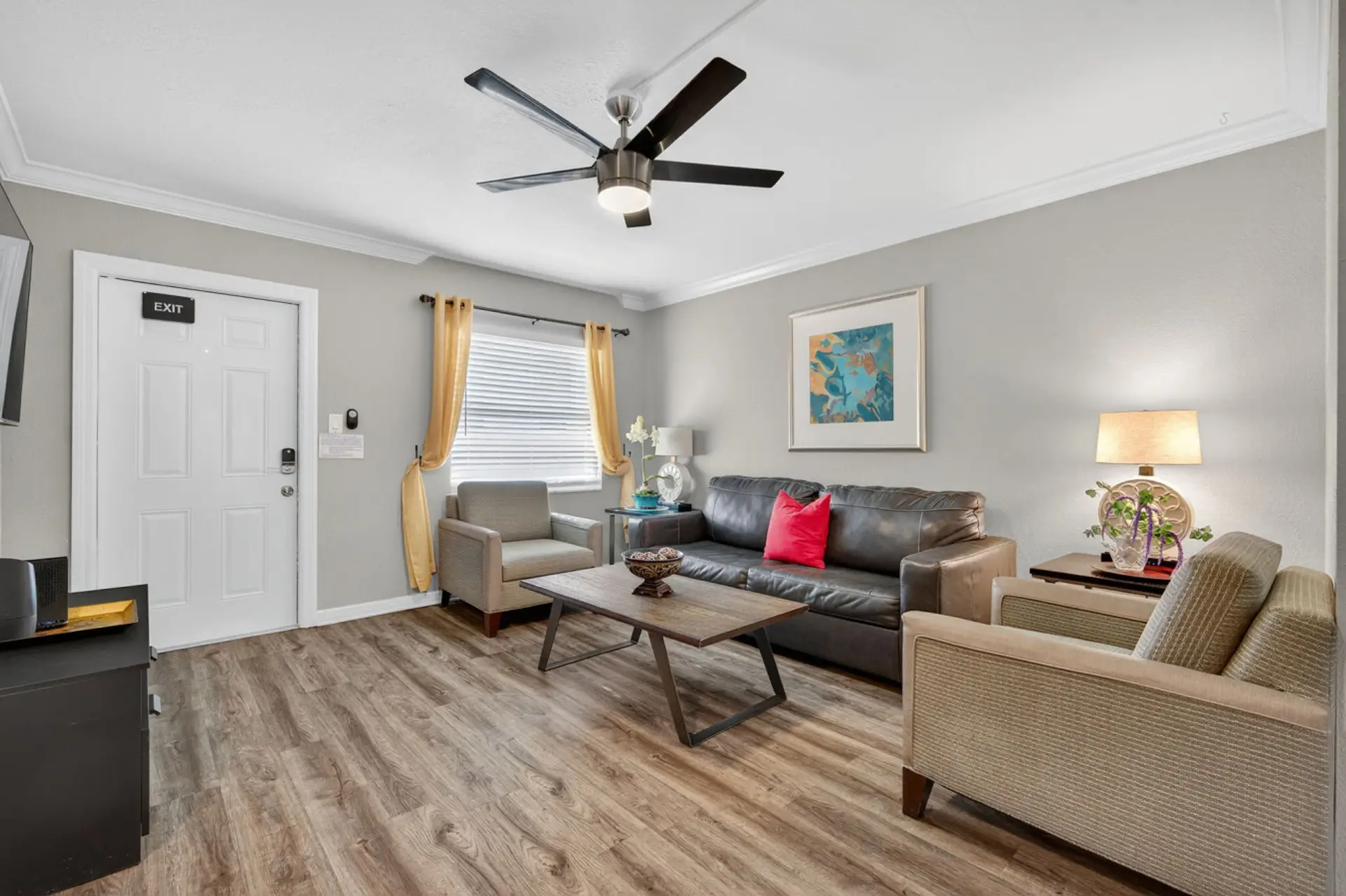 Bright living room w/ comfy seating, warm accents & an open layout perfect for relaxing together.