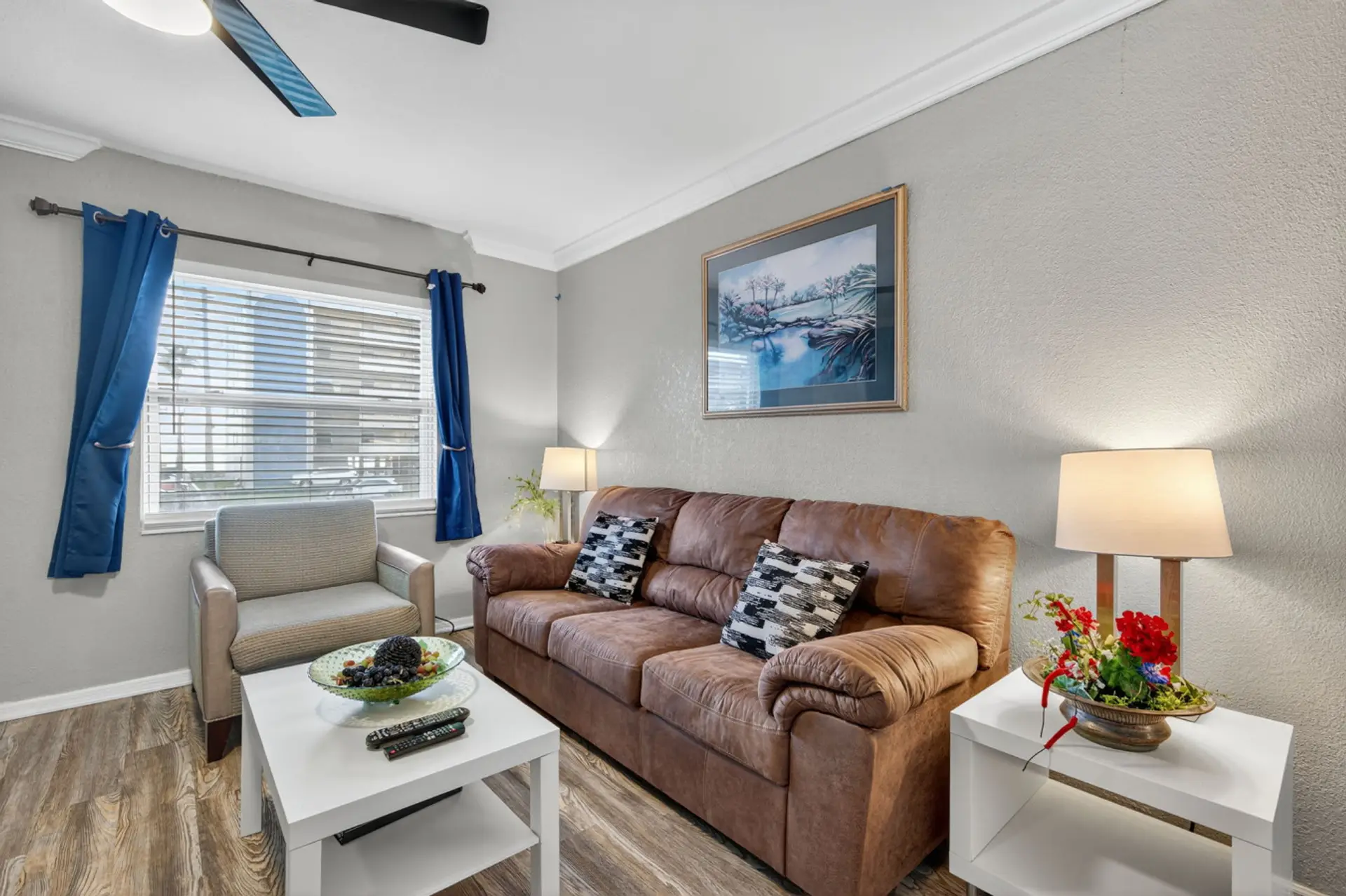 Cozy living room w/ comfy sofa, soft lighting, and blue accents for relaxed evenings indoors.