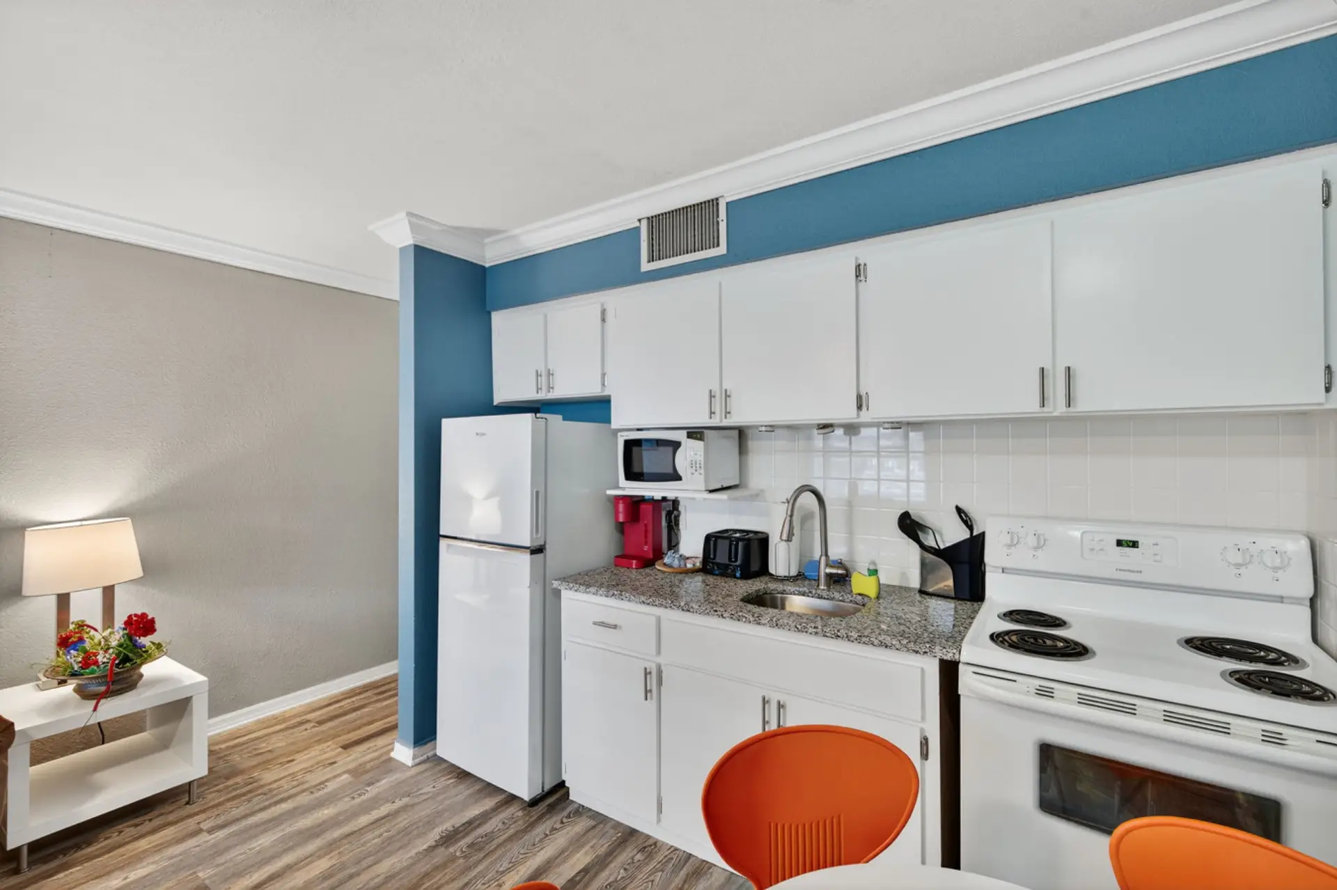 Bright kitchen w/ white cabinetry and clean lines, perfect for easy meals and snacks.