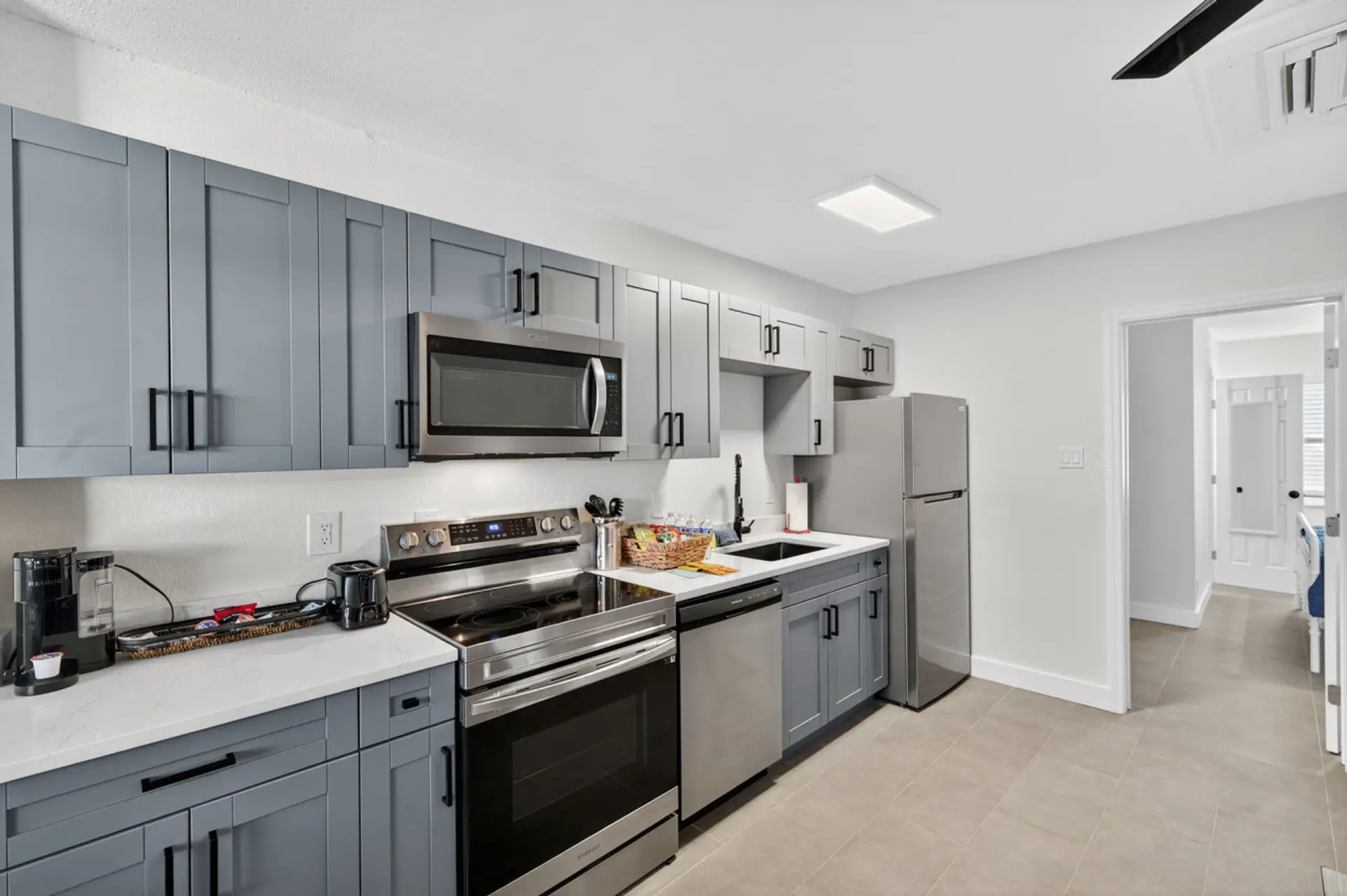 Modern kitchen w/ stainless steel appliances & plenty of prep space