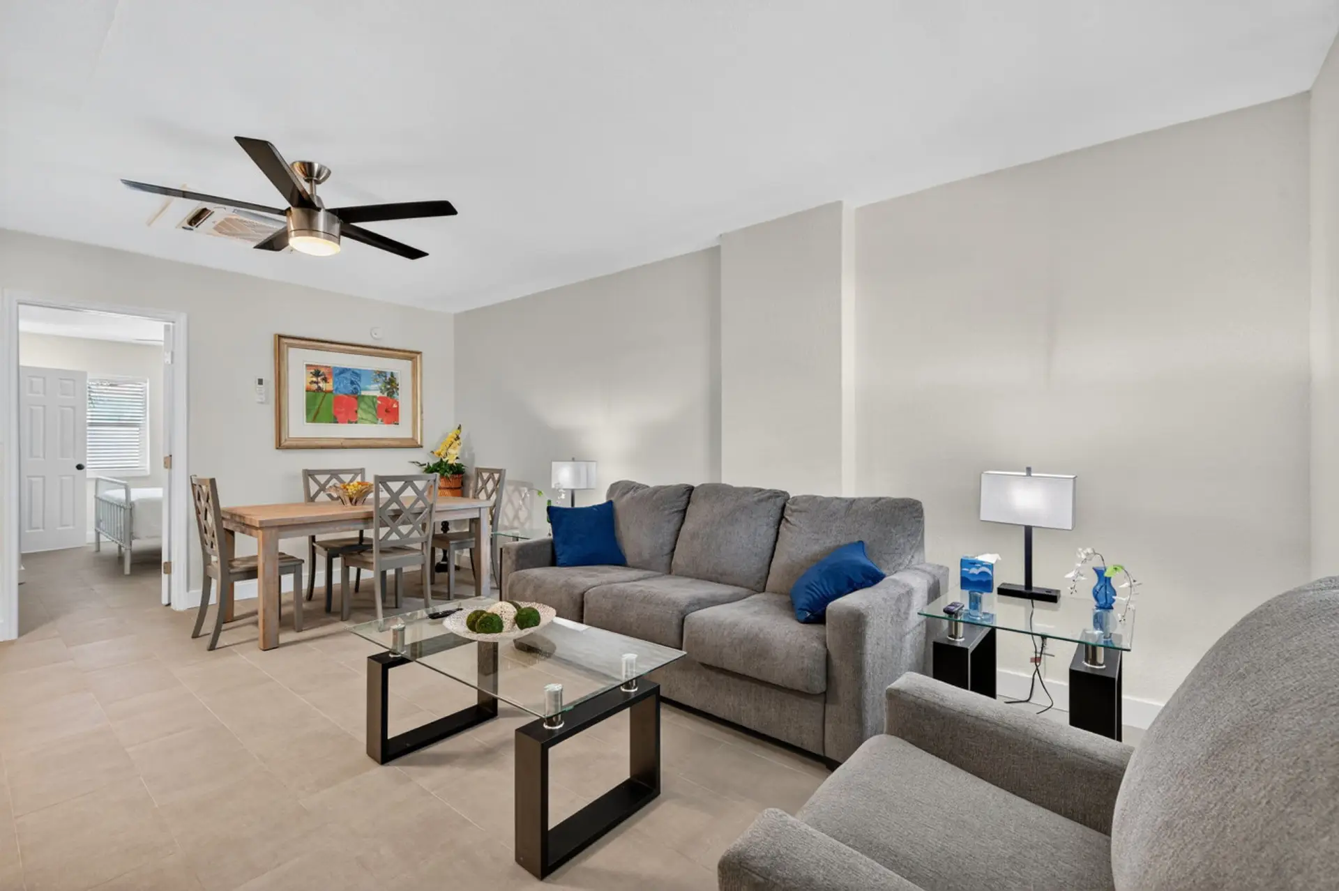 Bright living room w/ comfy sofa, clean lines, & an inviting layout for unwinding