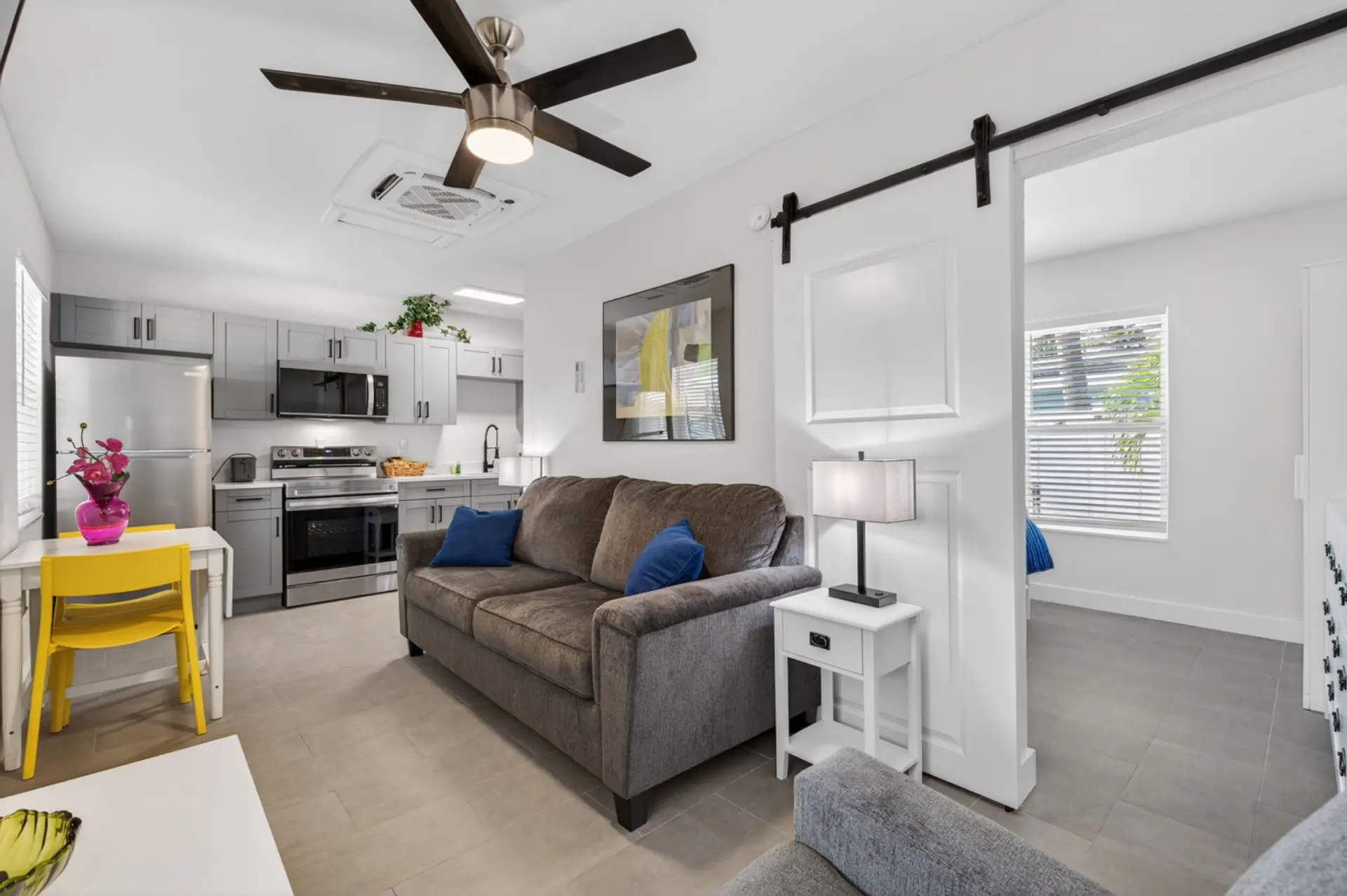 Bright open living area w/ cozy seating that flows easily into the kitchen for easy gatherings