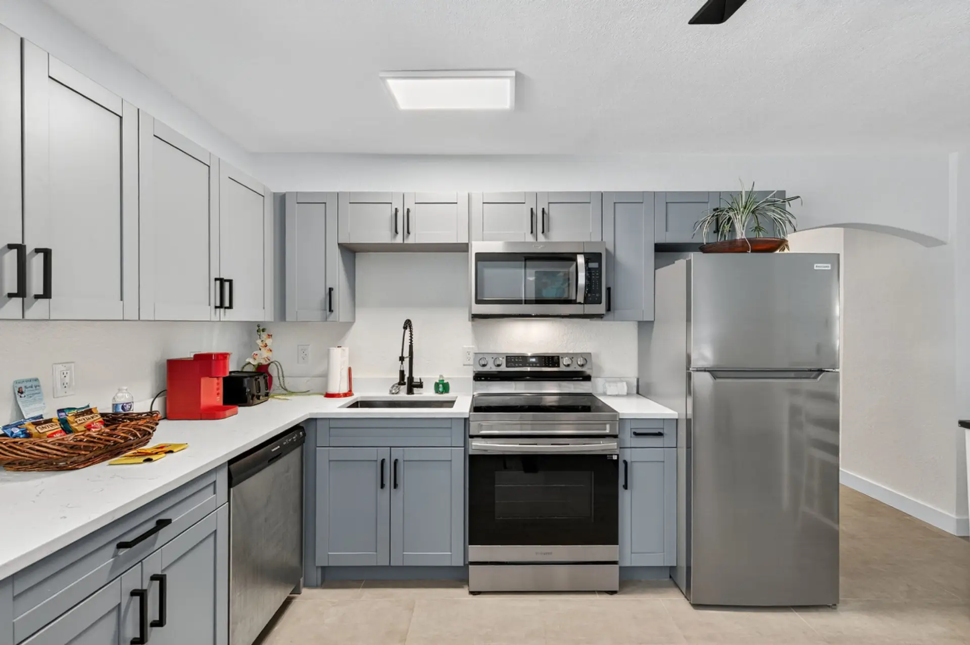 Contemporary kitchen w/ clean white cabinets and an efficient, open layout.