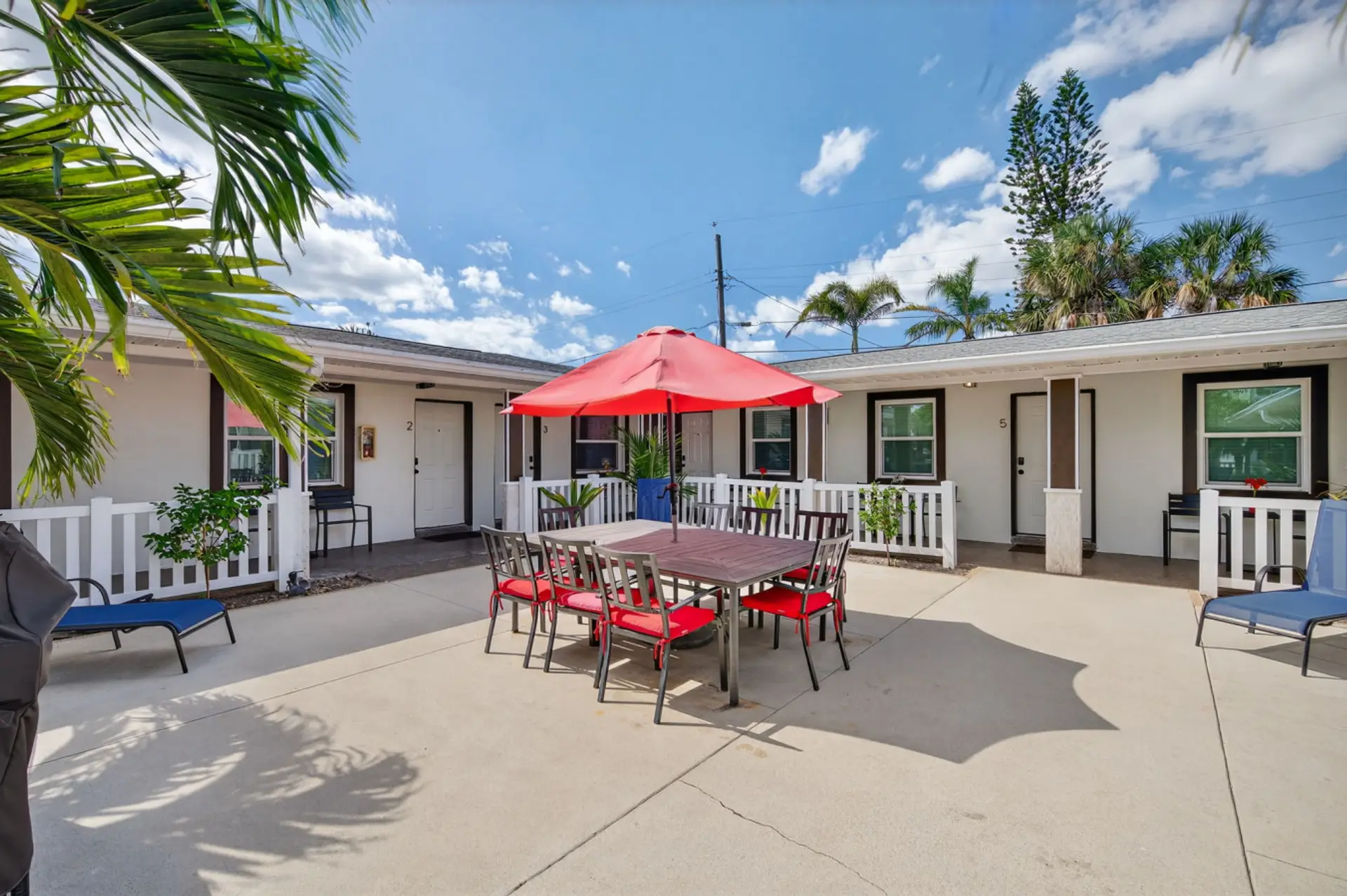 Sunlit patio w/ grill and outdoor seating, perfect for relaxed meals and easy entertaining.