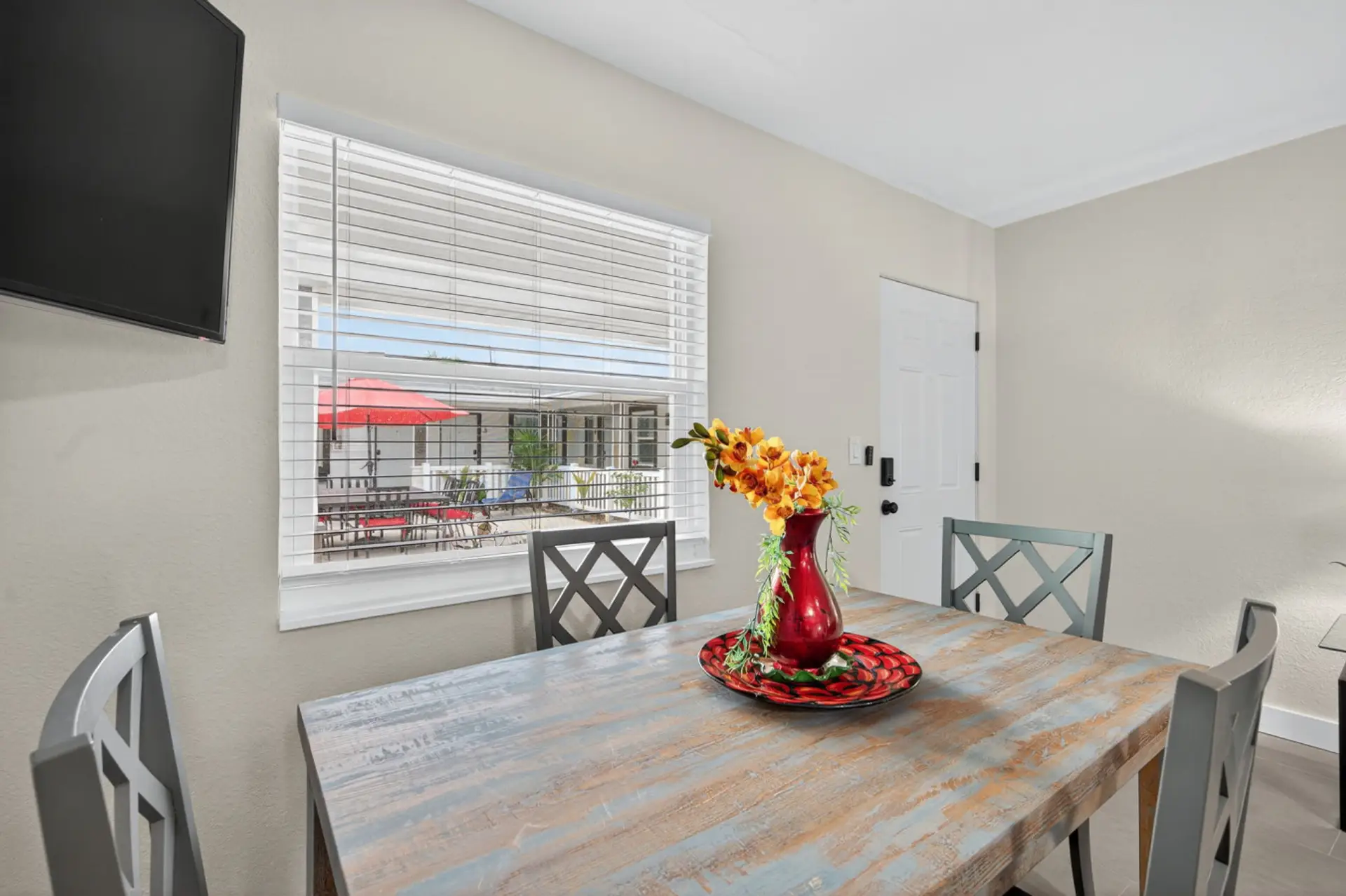 Dining area set for shared meals, featuring a bright table & modern accents.