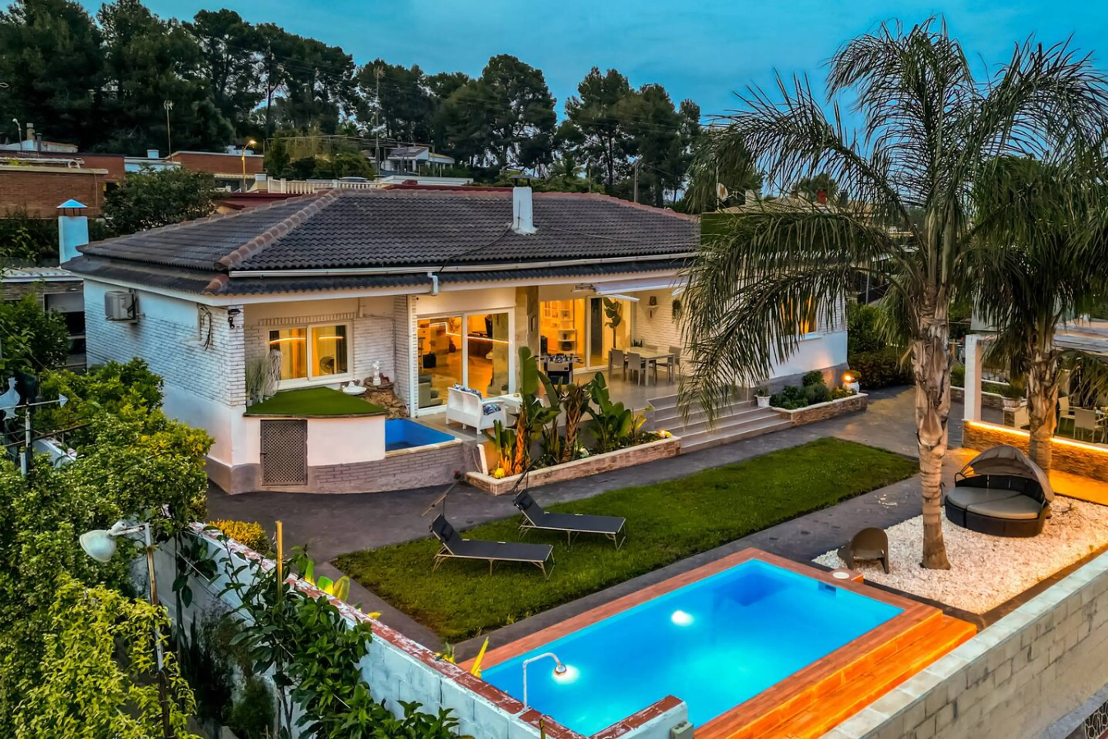 Exterior Oasis: Dive into luxury with a sparkling pool and vibrant gardens perfect for relaxation!