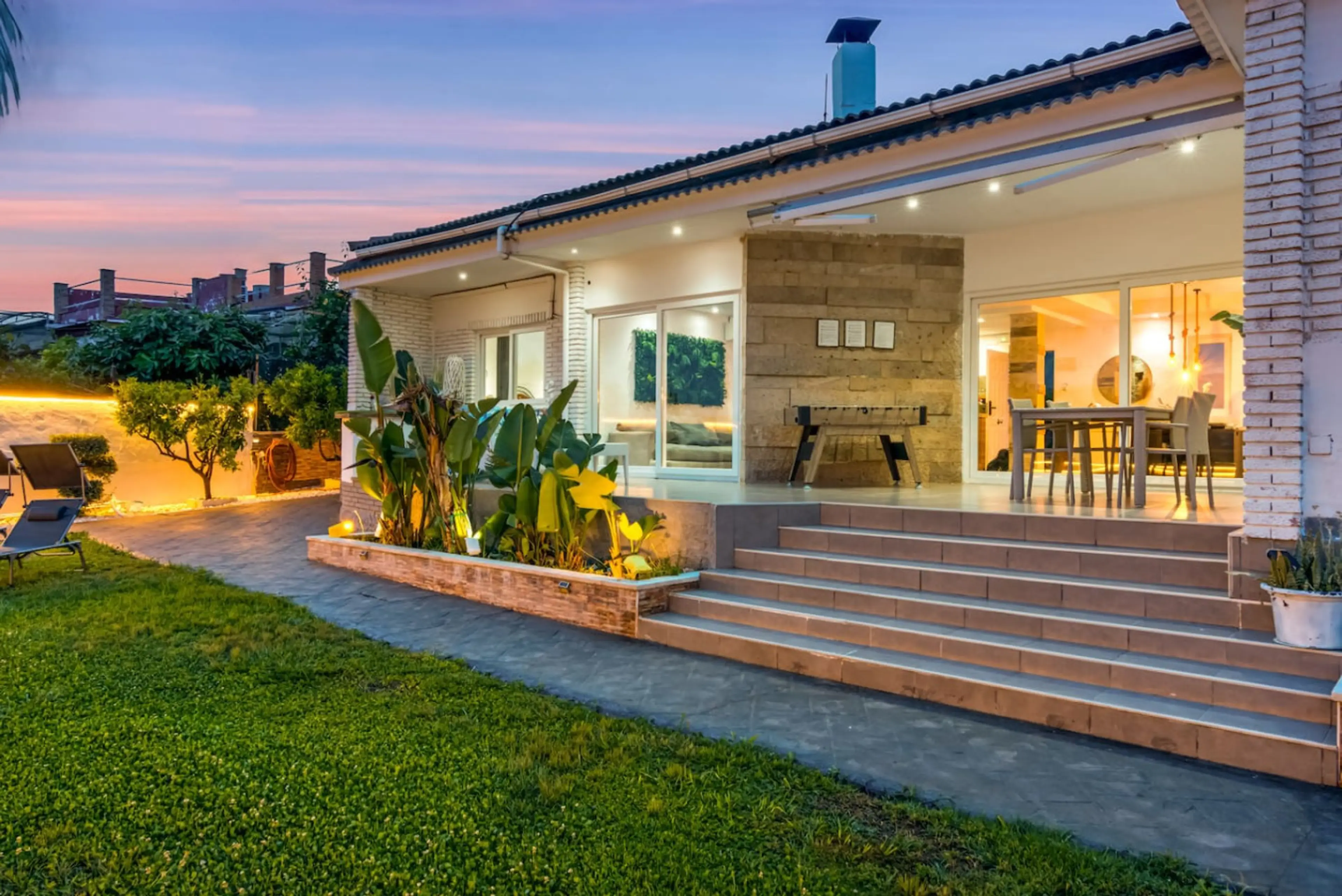 Exterior Serenity: Step into a beautifully lit garden oasis, perfect for sunset relaxation!