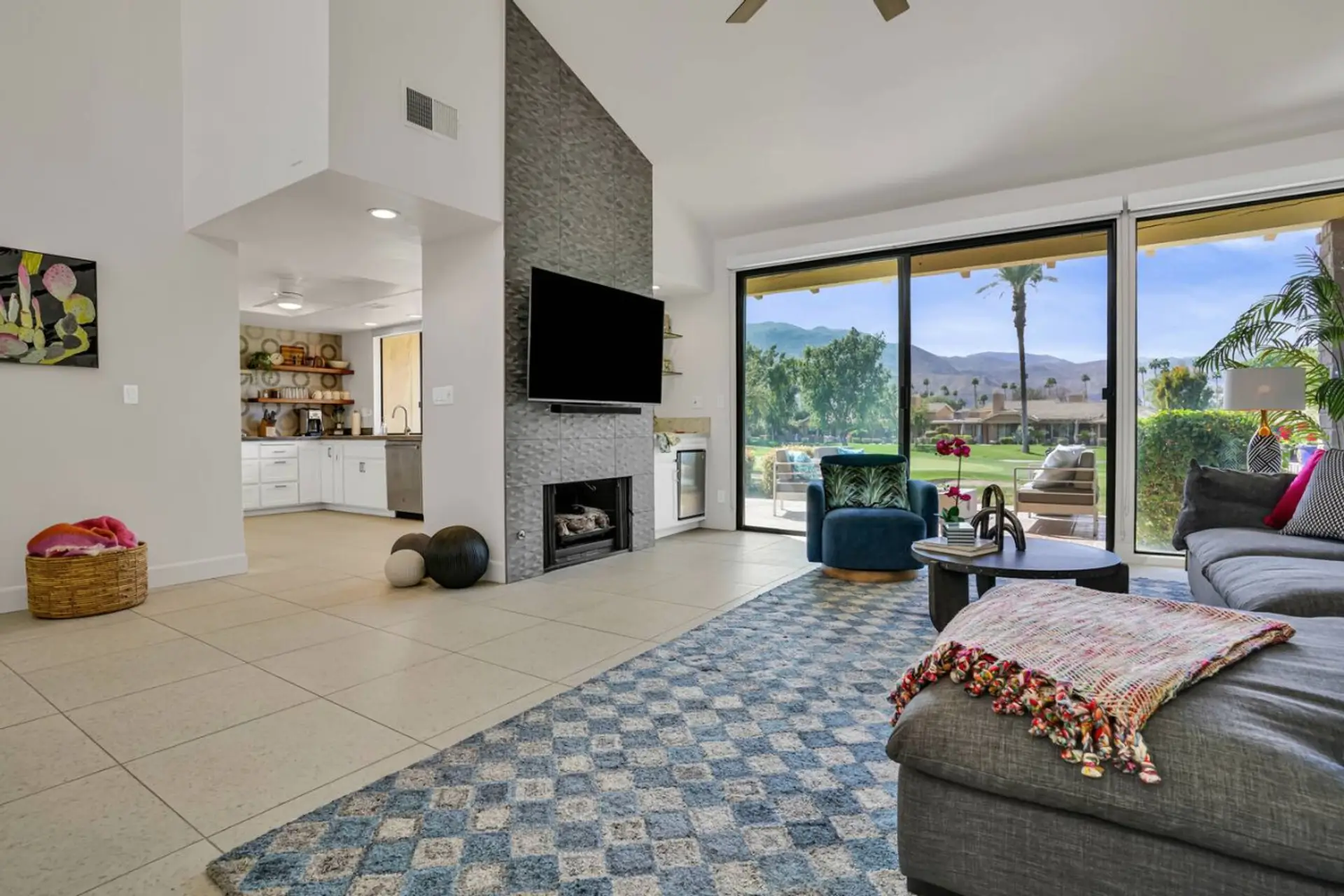 Spacious living room, modern aesthetic, large TV.