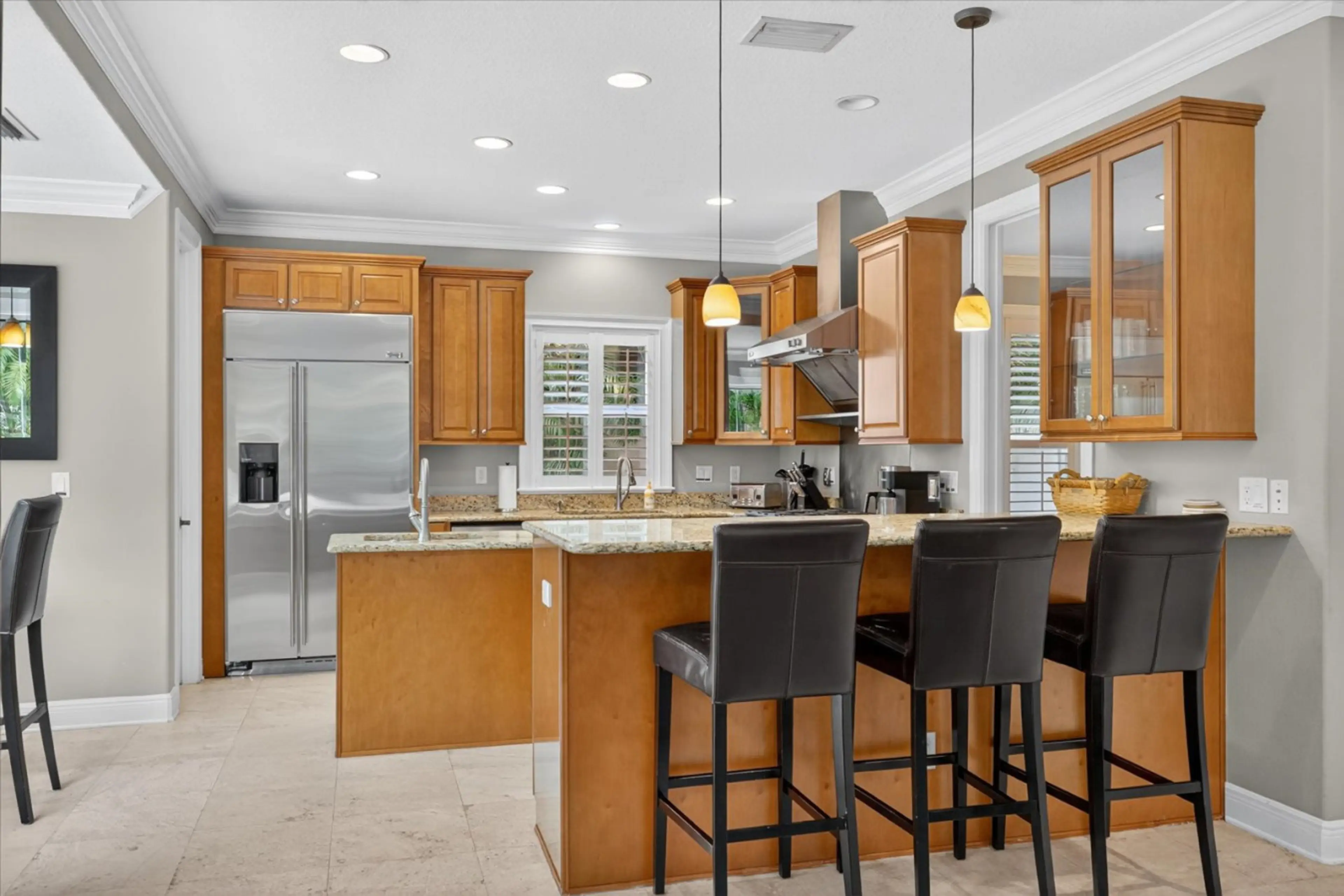 Open kitchen with bar seating and premium finishes