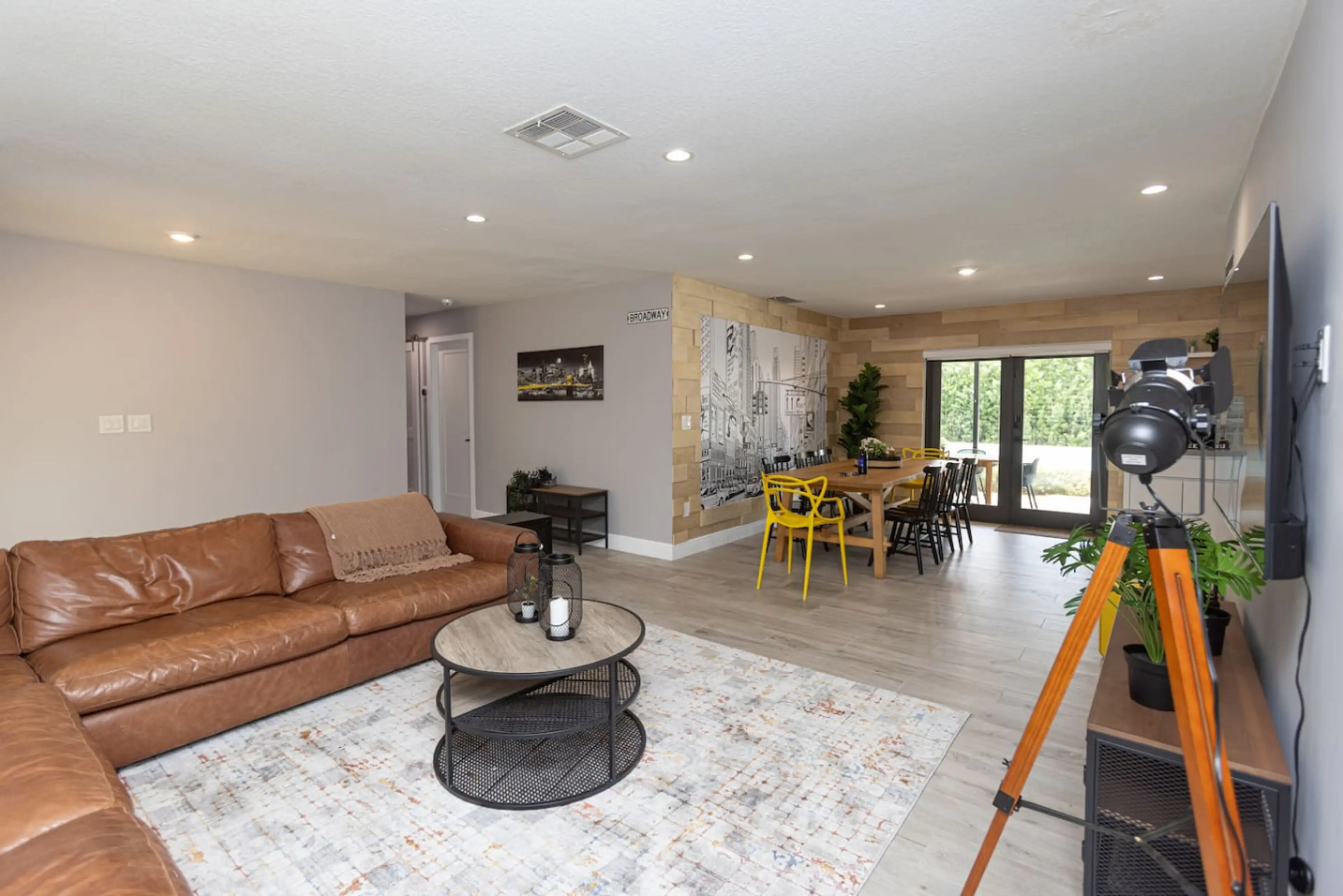 Spacious family-friendly living room with cozy seating and open dining area — the perfect Miami retreat to relax and connect.