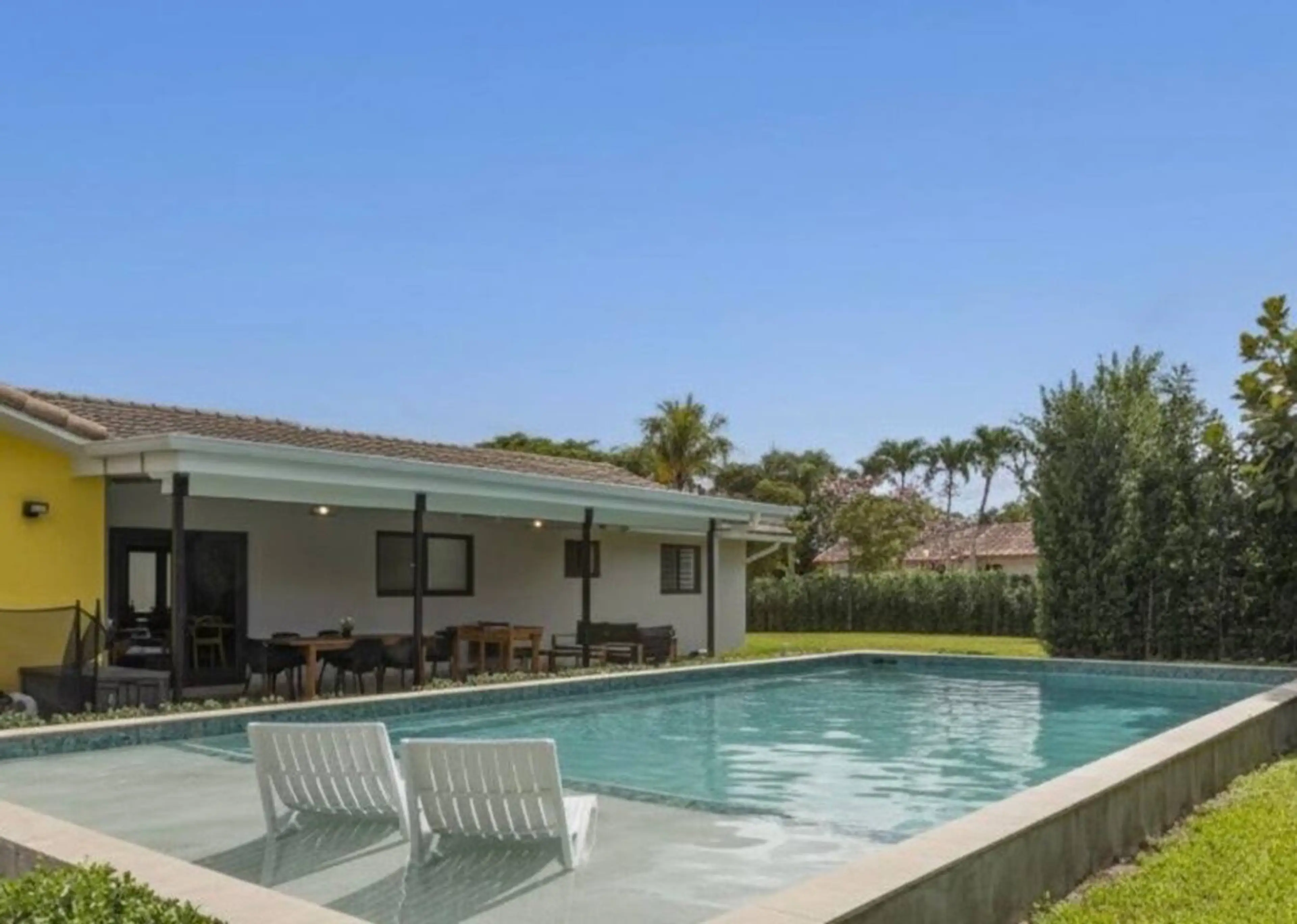 Relax by the private heated pool with in-water loungers — your Miami vacation rental oasis for sun, fun, and family time.