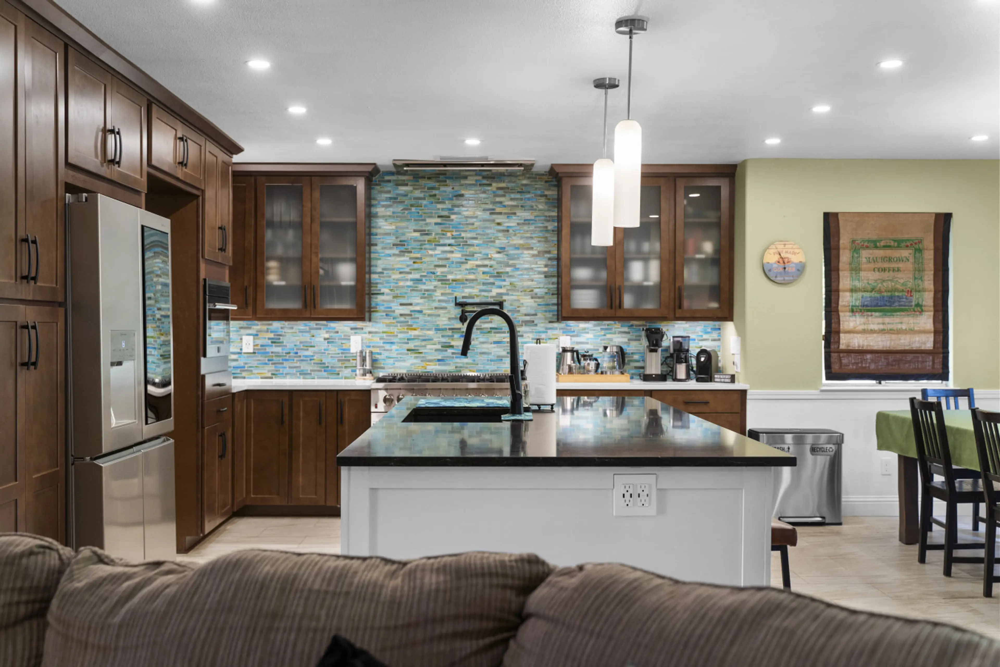 Modern kitchen with full appliances, cooking essentials, and dining island ideal for families and extended stays.