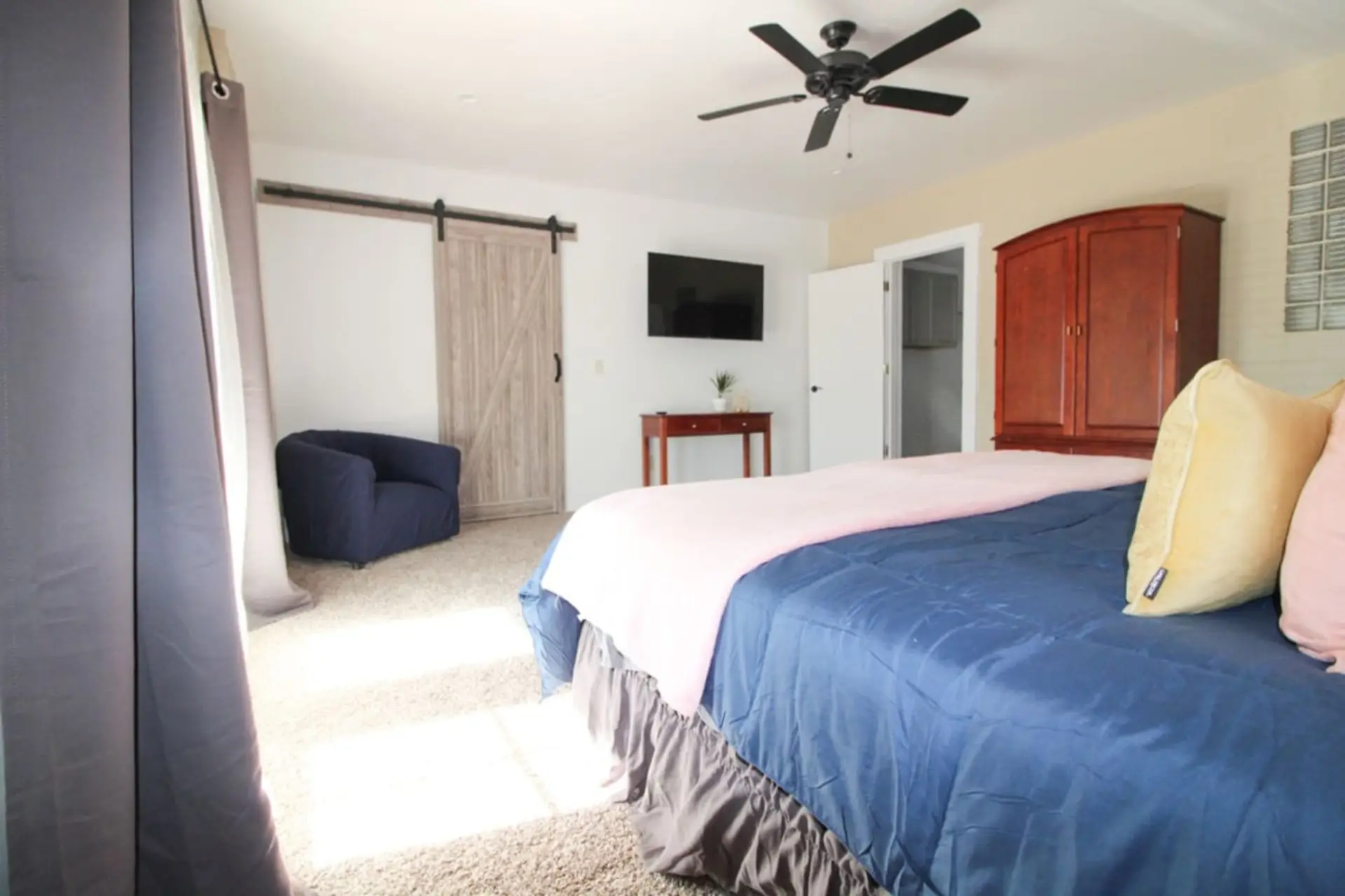 Primary bedroom with king bed, en-suite bathroom, and smart TV