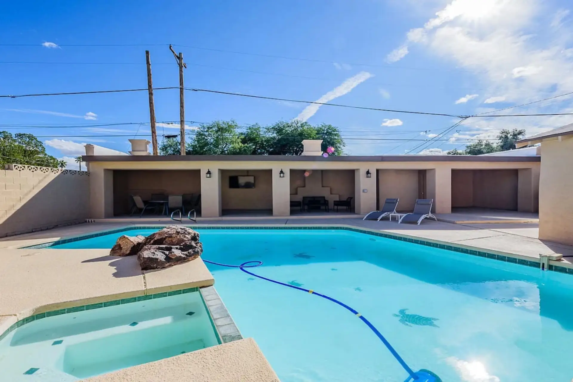 Lounge chairs, a covered patio with TV and fireplace, and a tall privacy fence all the way around (pool and hot tub heated for an additional fee)