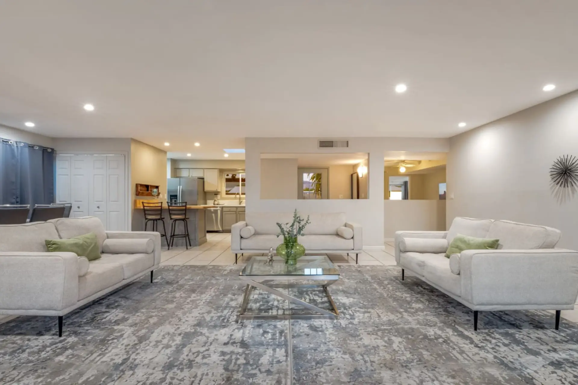 Beautiful, grand living room that leads to the dining area and kitchen