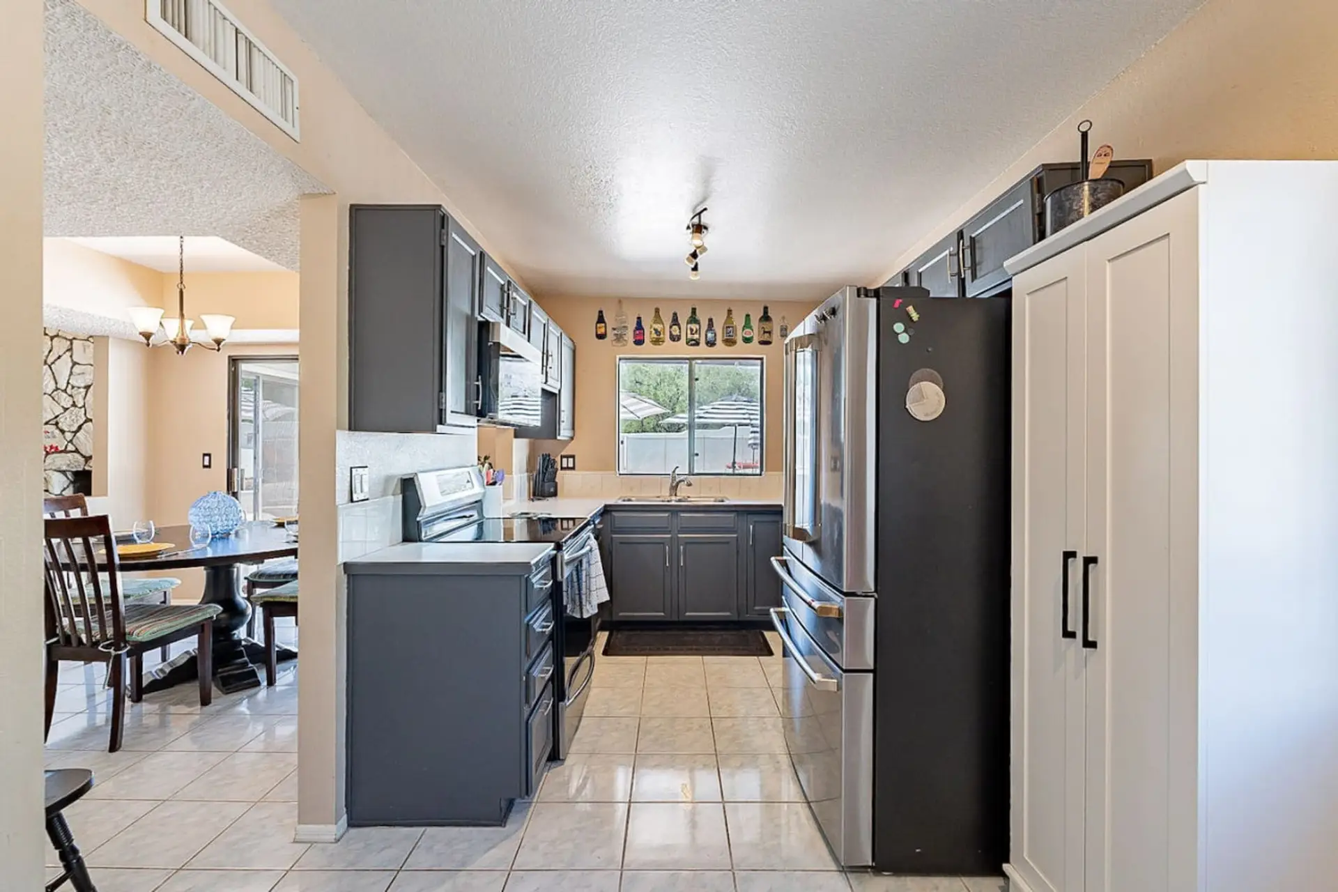 Well-equipped kitchen with stainless steel appliances and view of the backyard