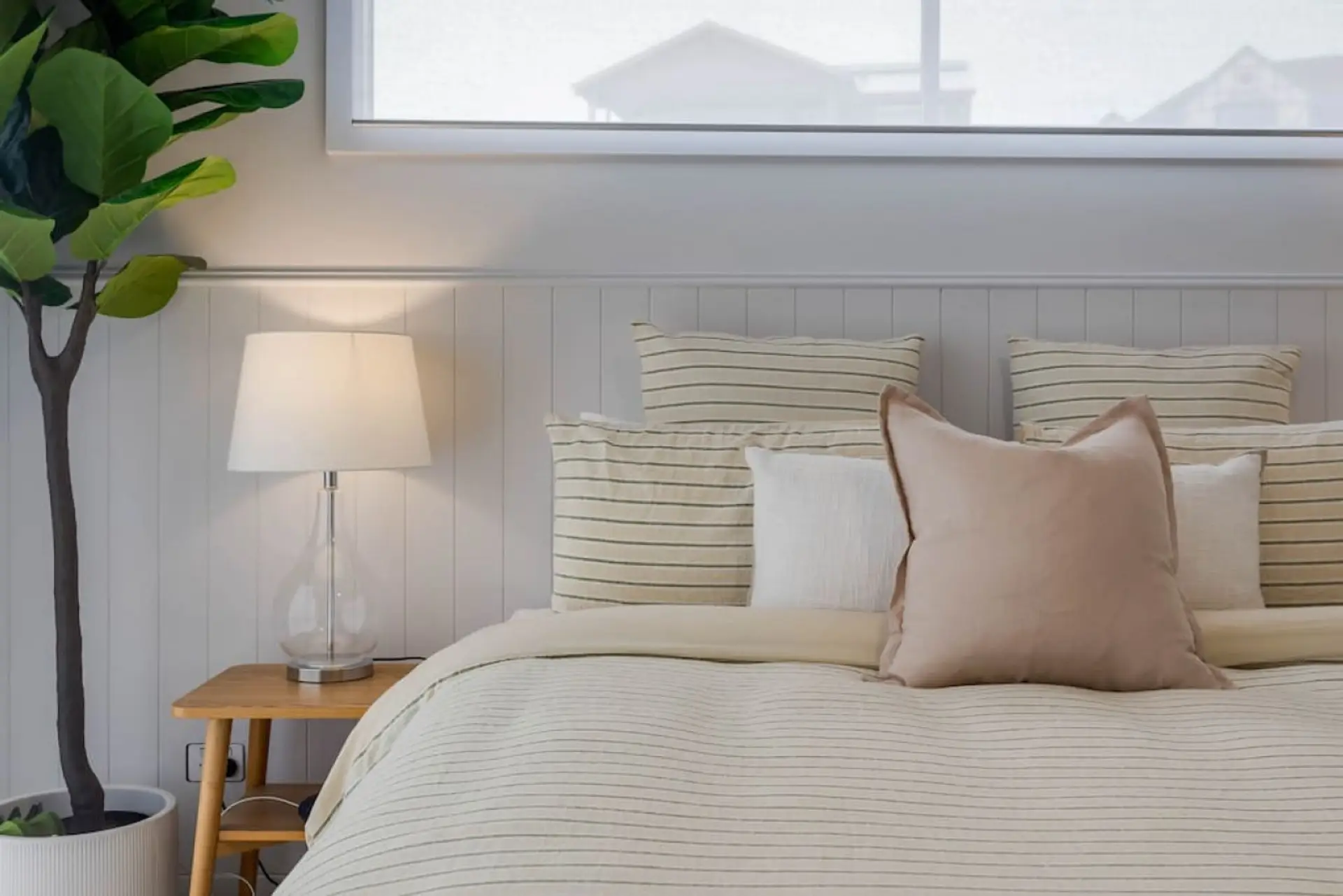 This tranquil bedroom boasts a soft pastel color scheme, creating a serene and calming atmosphere that invites relaxation and rejuvenation.