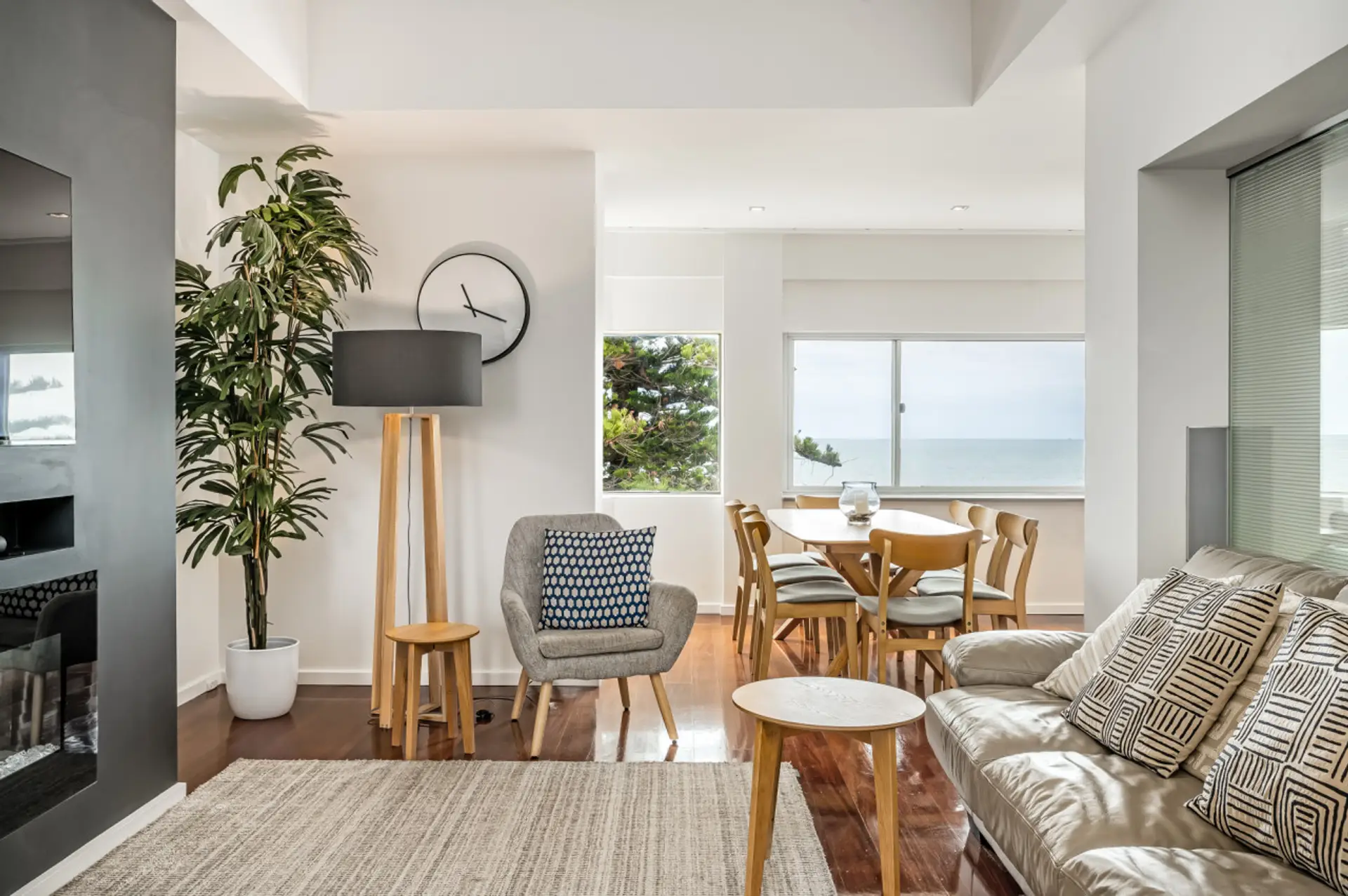 The living room boasts a warm, inviting atmosphere, thanks to its beautifully crafted wooden setup. The wooden accents and furniture pieces blend seamlessly with the plush sofa, creating a cozy and rustic ambiance that's perfect for relaxation and sociali