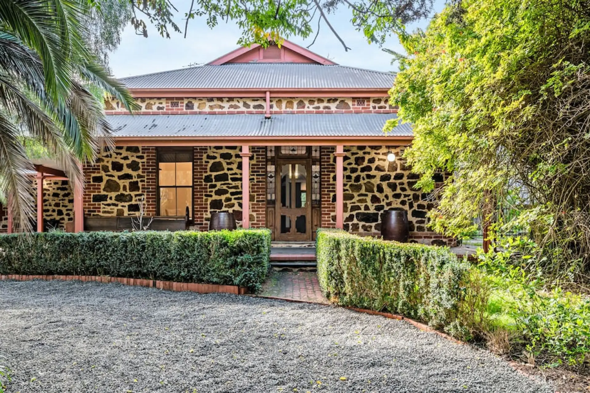 The house presents a majestic exterior, with grand architectural details, elegant lines, and a commanding presence. Surrounded by manicured landscaping and framed by natural beauty, its stately facade and timeless charm make a stunning first impression.