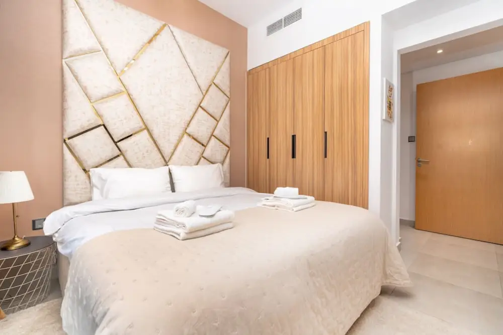 Master bedroom with sculpted headboard wall and full-width wardrobes