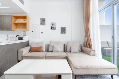 Living room with corner sofa, coffee table and terrace beyond