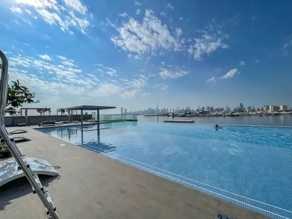 Infinity pool overlooking the water and the Dubai skyline