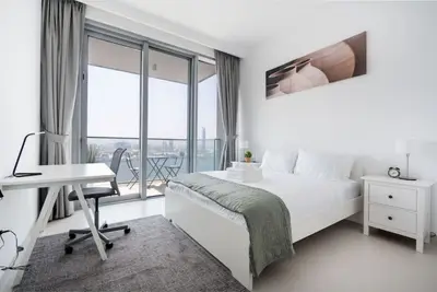 Master bedroom with double bed, work desk and balcony access