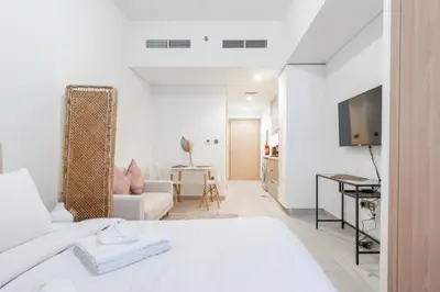 View from the bed toward the lounge corner, dining nook and entryway