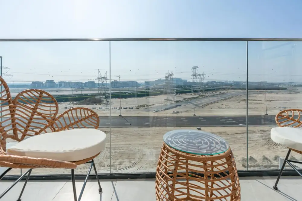 Rattan lounge chairs on the balcony facing wide open desert views