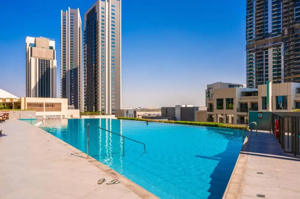 Resort-style outdoor pool framed by Creek Harbour towers