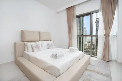 Serene bedroom with floor-to-ceiling windows and skyline glimpses