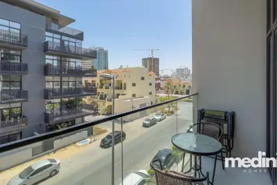 Balcony bistro table overlooking a quiet residential street