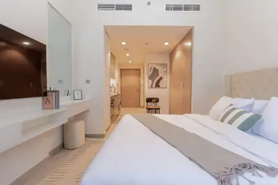 The sleeping area with vanity desk, seen toward the entrance hall