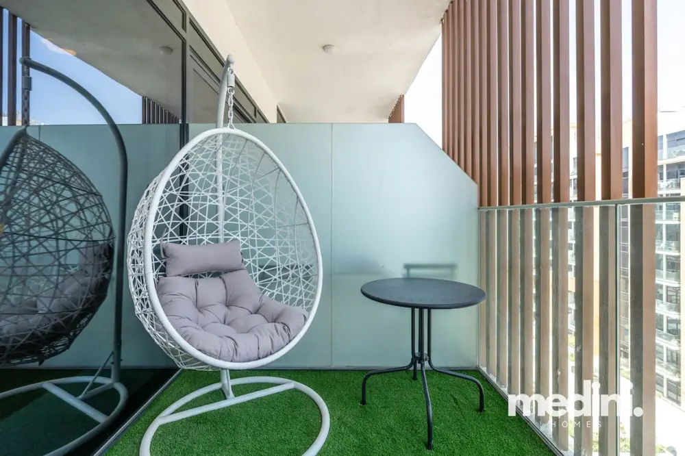Hanging egg chair on the astroturf balcony