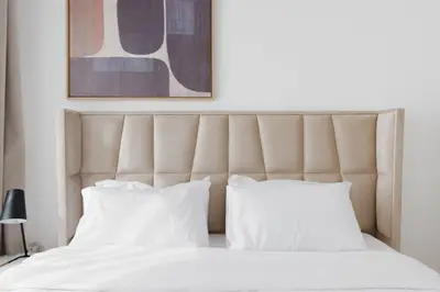 Close-up of the channel-stitched headboard and artwork above the bed