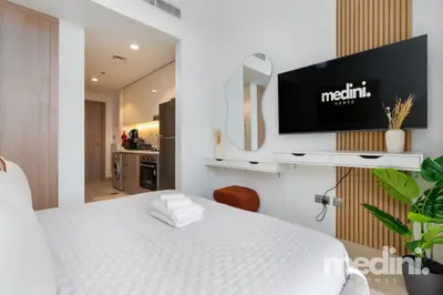 Studio view from the bed toward the open kitchenette