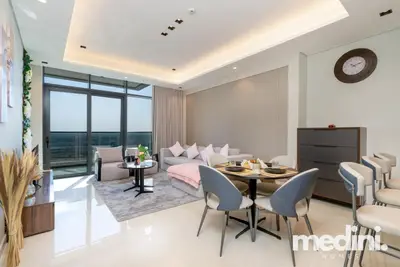 Open-plan lounge and dining space with round table set for four