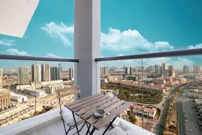 High-floor balcony with bistro seating overlooking the skyline