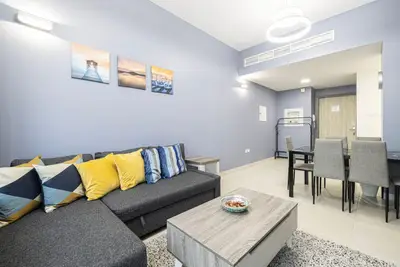 Another view of the living room, corner sofa facing the dining table