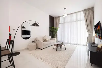 Living room seen from the entrance with arc floor lamp and coffee table