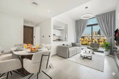 Open-plan dining and living area with kitchen pass-through in the background