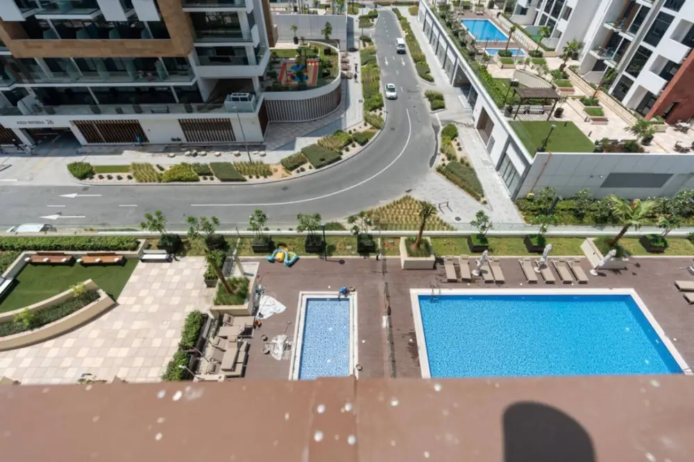 Aerial view of the outdoor pool and surrounding residential buildings