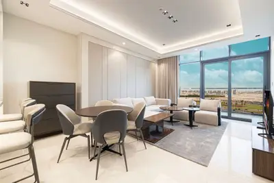 Open-plan living and dining area with round table and large window
