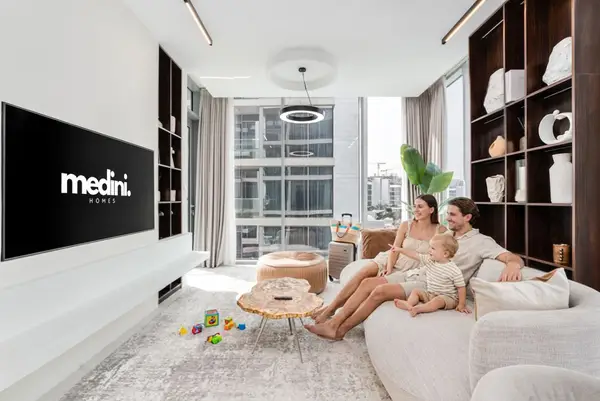 Living room with cream sofa, wood shelving, and large city-view windows
